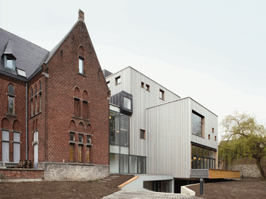 The old and new buildings connect through a glazed corridor