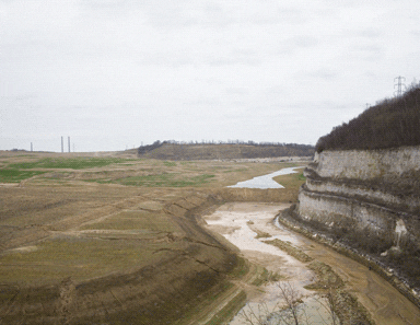 The chalk cliffs at the southern edge of the quarry. The pits at the bottom will be flooded to create lakes The chalk cliffs at the southern edge of the quarry. The pits at the bottom will be flooded to create lakes