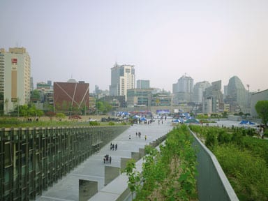 The ramp leads down between the two halves of the building