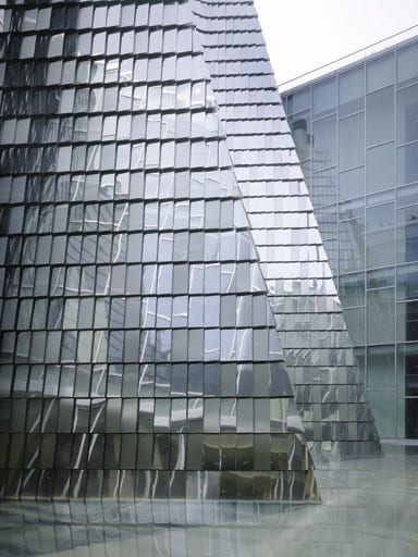 Mirrored stainless steel fins reflect light into the lower floors