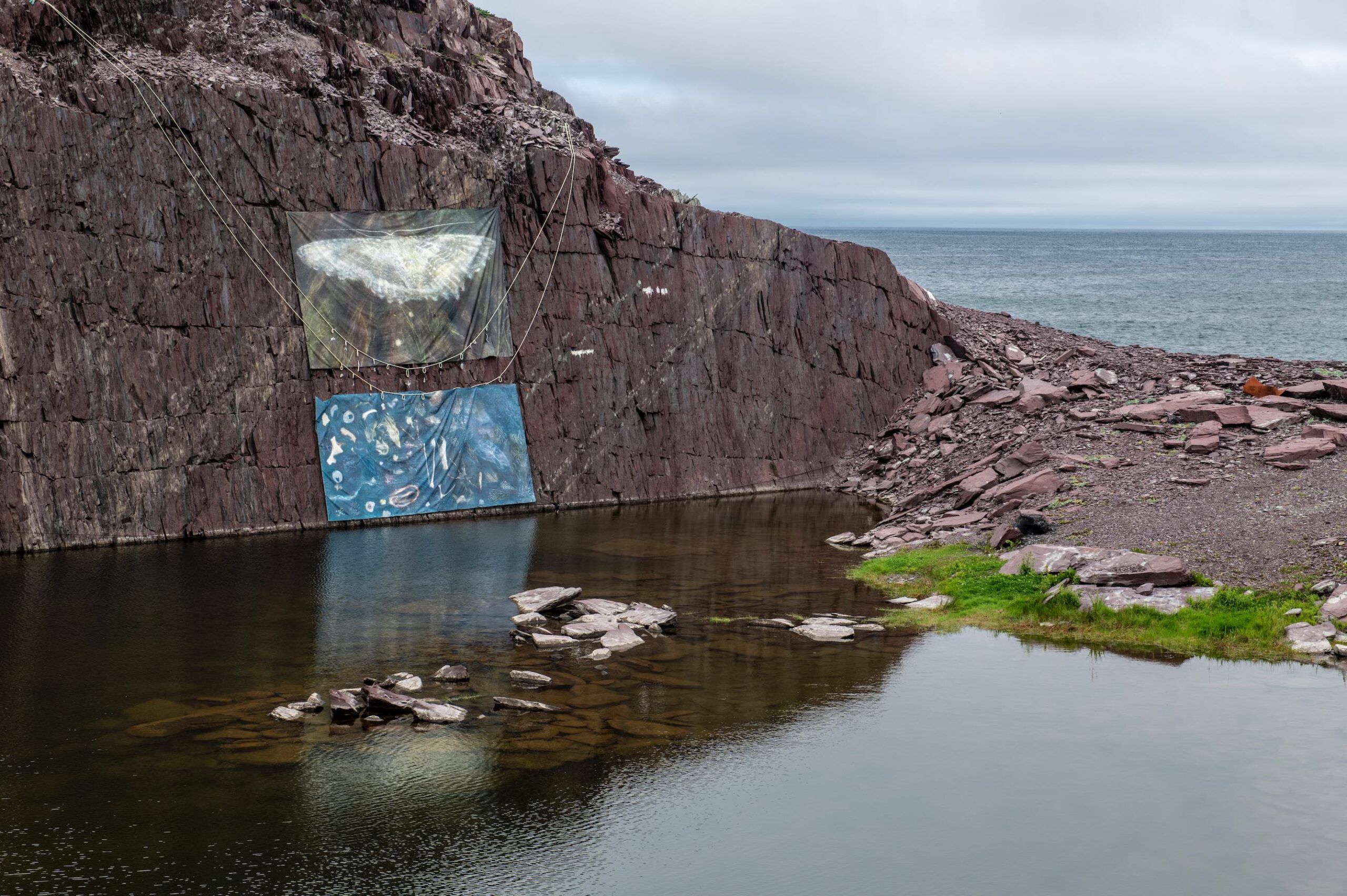 Bonavista Biennale SK Maston, Deep Time Drift (beaks hid in the hole a seal fin, rib bone, rabbit paw fur), 2023, acrylic on printed canvas, rope, aluminum casts. Canada